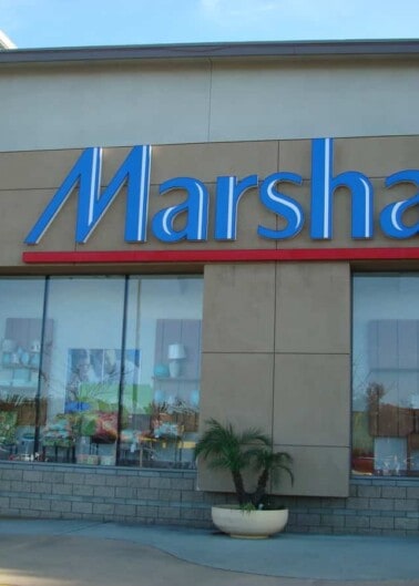 Storefront of a marshalls retail store with large signage and reflective windows.