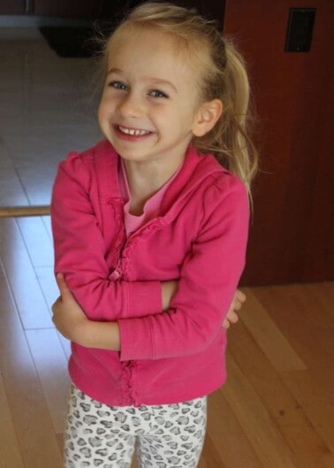 Young girl smiling with arms crossed