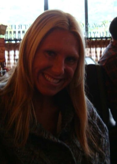 Woman smiling while sitting at restaurant