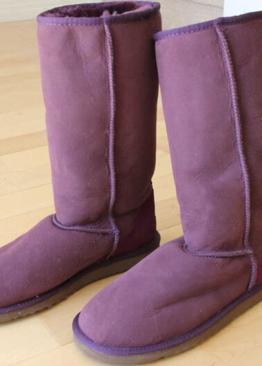 Purple colored boots on floor