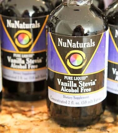 Bottles of nunaturals vanilla stevia, alcohol-free dietary supplement on a countertop.