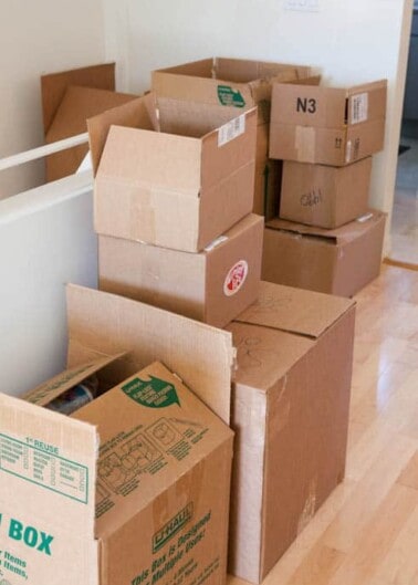 Stacked moving boxes in a room, indicating a packing or unpacking process.