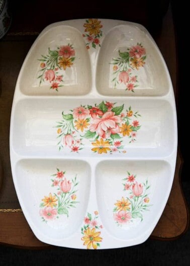 A ceramic divided serving tray with a floral pattern.