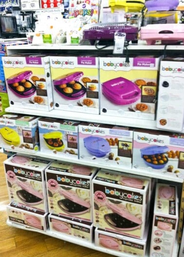 Aisle in a store displaying a variety of 'babycakes' brand kitchen appliances on shelves.