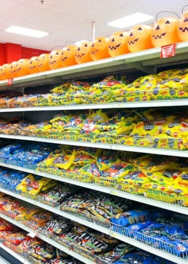 Aisle in a store stocked with various bags of halloween candy.