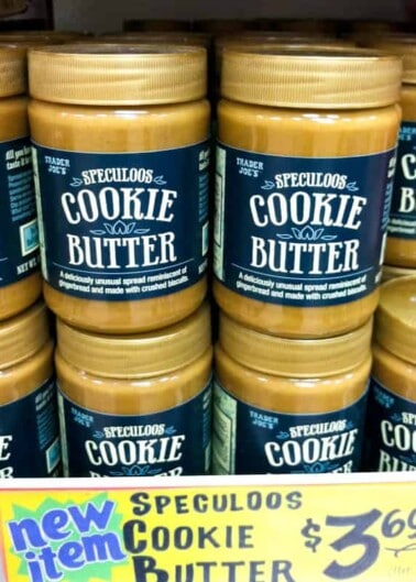 Jars of speculoos cookie butter on a store shelf, with a price tag indicating it is a new item.