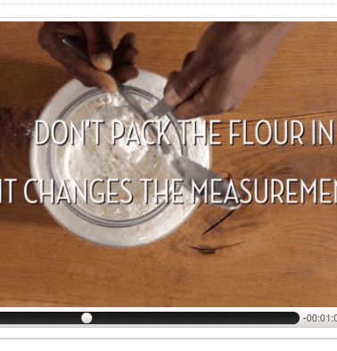 A screen capture from a cooking tutorial with an overlay text that reads: "don't pack the flour in it changes the measurement.