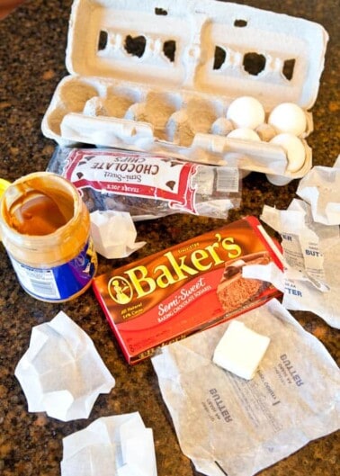 Various baking ingredients and an empty egg carton on a kitchen counter.