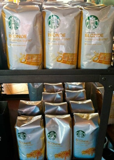 Shelves stocked with bags of starbucks blonde veranda blend coffee.