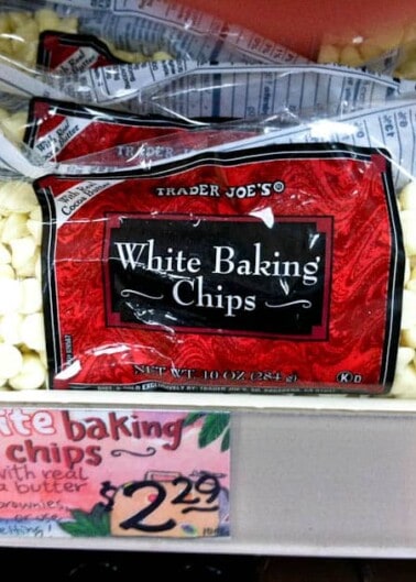 Packages of white baking chips on a store shelf, priced at $2.29 each.