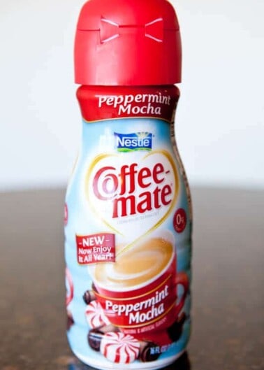 A bottle of nestlé coffee-mate peppermint mocha creamer on a counter.