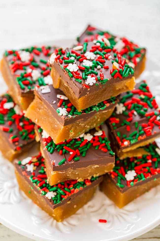 A plate stacked with chocolate-topped bars, adorned with red, green, and white sprinkles.