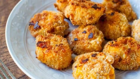 Golden-brown breaded nuggets served on a plate.