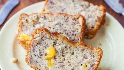 Slices of banana bread with visible banana chunks on a plate.