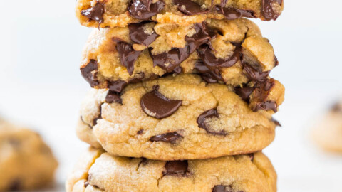 A stack of chocolate chip cookies on a white background.