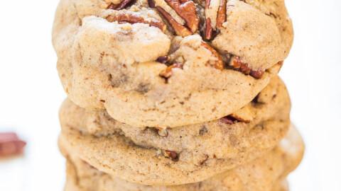 A stack of pecan cookies on a white surface.