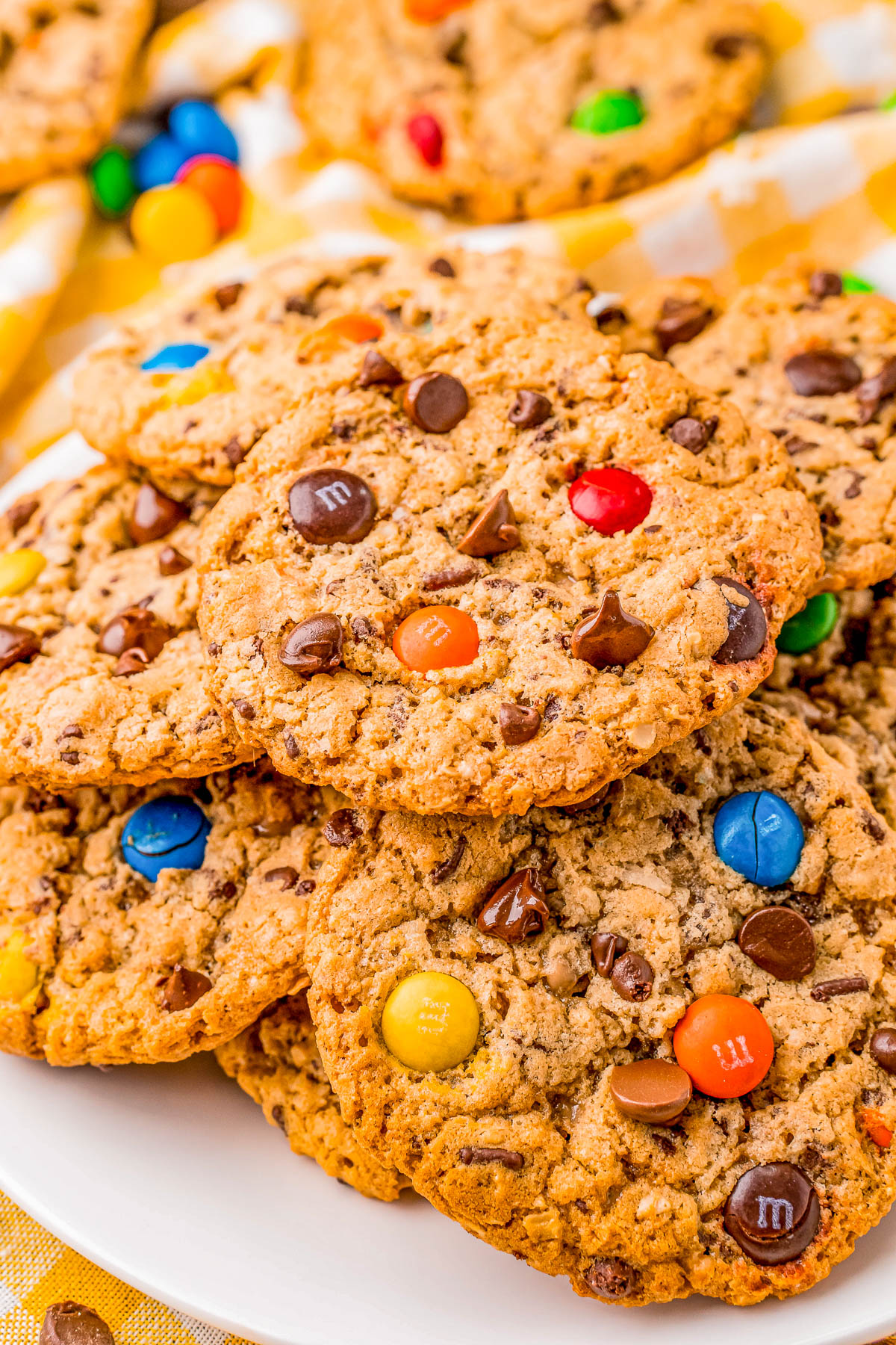 A plate of cookies with colorful candy-coated chocolates and chocolate chips on top.