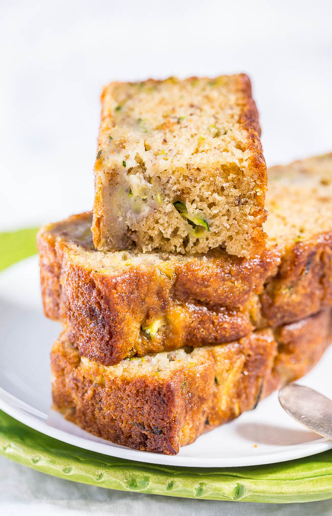 Sliced zucchini bread on a white plate.