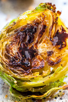 A close-up of a roasted brussels sprout with charred edges.