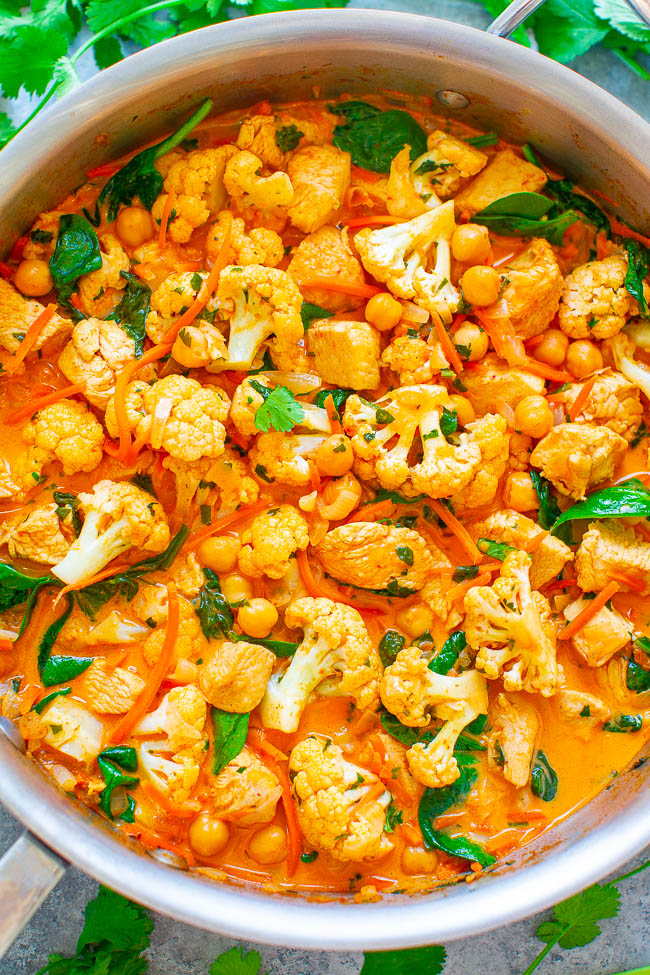 Cauliflower, Chickpea, and Chicken Coconut Curry - An EASY, one-skillet curry that's ready in 20 minutes and tastes BETTER than a restaurant!! The Thai-inspired coconut milk broth makes this healthy comfort food taste AMAZING!!
