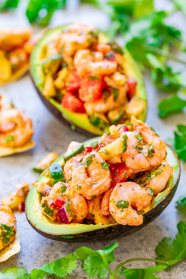 Shrimp Stuffed Avocados - If you like ceviche, you're going to LOVE these EASY avocados stuffed with a mixture of shrimp, tomatoes, cucumber, red onions, and more - plus some hot sauce for a touch of heat!! There's a time-saving shortcut so these are ready in 15 minutes with no fuss!!