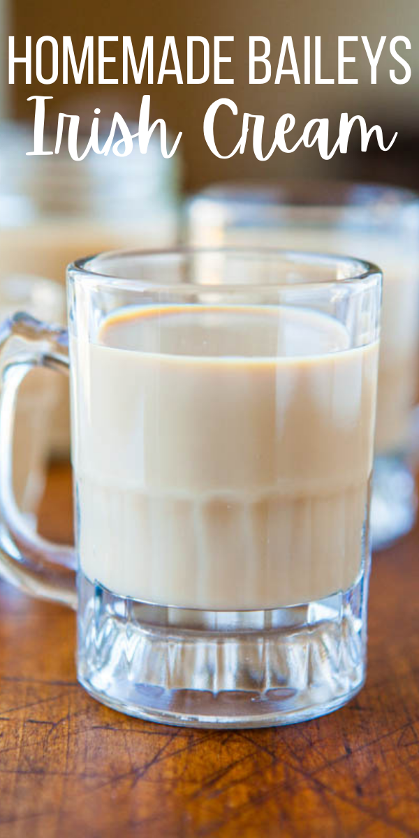 A glass of homemade Baileys Irish Cream on a wooden surface.