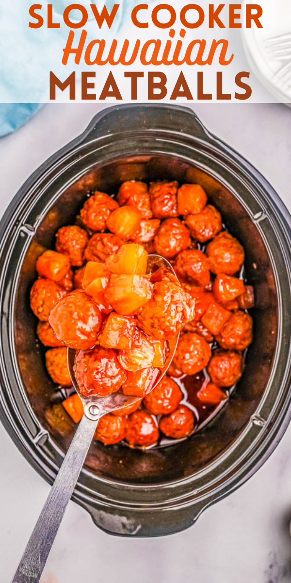 Slow cooker filled with Hawaiian meatballs in sauce, shown with a spoon lifting some out.