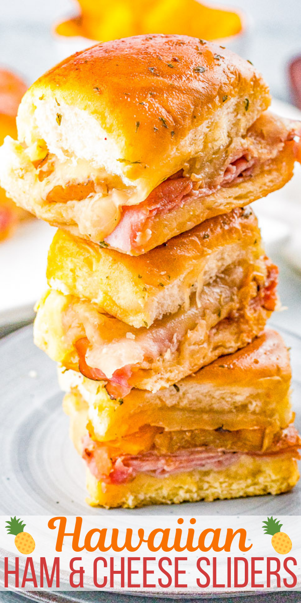 A stack of three Hawaiian ham and cheese sliders on a plate, featuring layers of ham and cheese on soft buns.