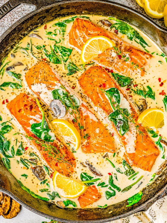 Salmon Florentine - You don't need to go to Florence, Italy to enjoy this FAST and EASY Italian-inspired salmon recipe at home! Tender flaky salmon is bathed in a decadent cream sauce made with heavy cream, wine, Parmesan cheese, and more! Fresh spinach and mushrooms add extra texture and flavor to this super flavorful fish dish!