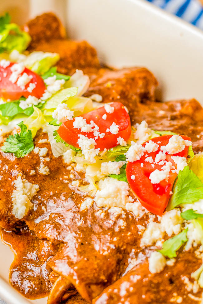 Chicken Mole Enchiladas - Lightly fried corn tortillas are stuffed with chicken, rolled up, and smothered in rich mole sauce for the best chicken mole enchiladas! A classic, Mexican-inspired family favorite comfort food recipe made FAST and EASY! A shortcut mole recipe that doctors up store bought mole is provided if you don't want to make homemade mole. 