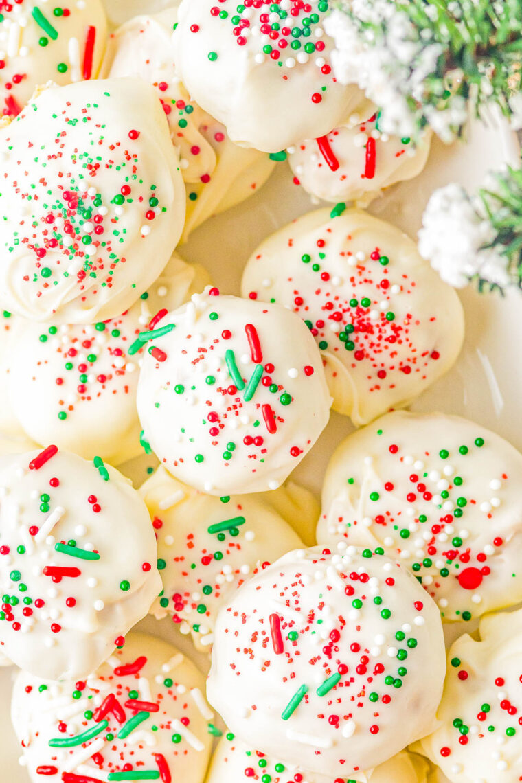 White Chocolate Peanut Butter Truffles - Fast, EASY, no-bake, and the BEST peanut butter truffles! A creamy peanut butter filling with a bit of texture from graham cracker crumbs, dipped in white chocolate (or milk or dark), and topped with sprinkles! Great MAKE-AHEAD homemade hostess gifts, for cookie exchanges, or set them out at Christmas parties.