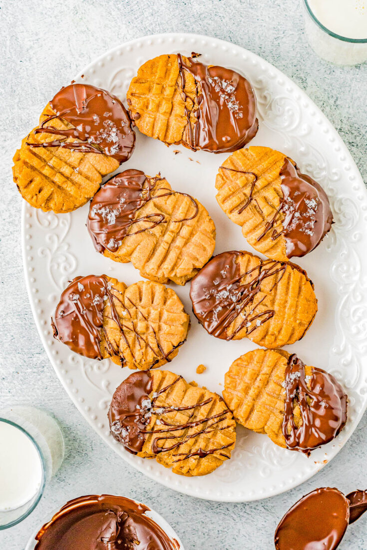 Homemade Nutter Butter Cookies - Homemade copycat Nutter Butters are so much better than the store bought originals! Creamy peanut butter filling is sandwiched between lightly crunchy peanut butter cookies. Pinches of optional sea salt and melted chocolate drizzled over the tops make these cookies simply THE BEST! 