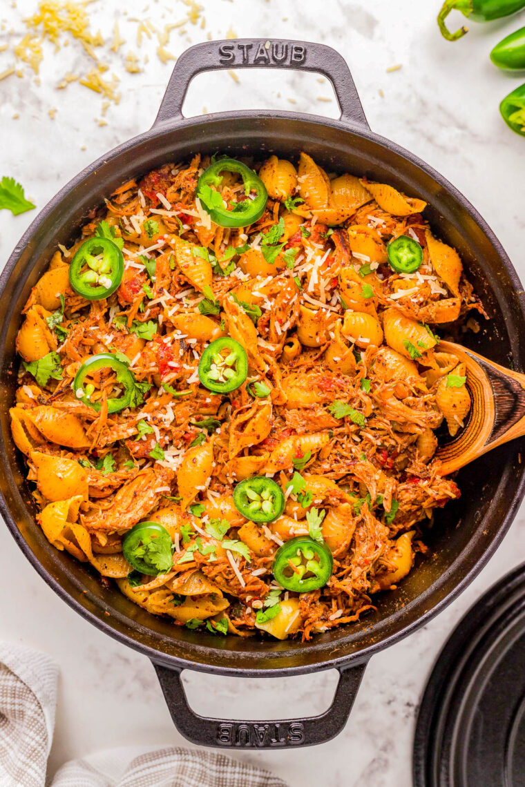 Chicken Chorizo Pasta - Tender pasta shells are mixed with chorizo and seasoned shredded chicken in a cream cheese and tomato based sauce for a truly FLAVORFUL comfort food dinner recipe! Ready in 45 minutes, EASY, and with just the right amount of heat to have everyone asking for seconds! 