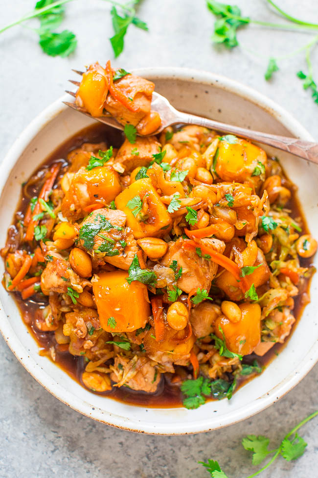 Sesame Mango Chicken in large white bowl with a fork