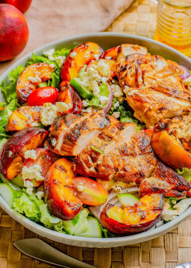 Grilled Peach and Chicken Salad with Lemon Vinaigrette — 🍑🥗🍋 Fresh peaches are grilled quickly on both sides before being tossed with juicy grilled chicken, crisp lettuce, salty feta, fresh mint, tomatoes, and more! Grilling peaches caramelizes them and infuses the salad with so much FLAVOR! Take advantage of seasonal summer produce while it lasts by making this EASY and crave-worthy salad!