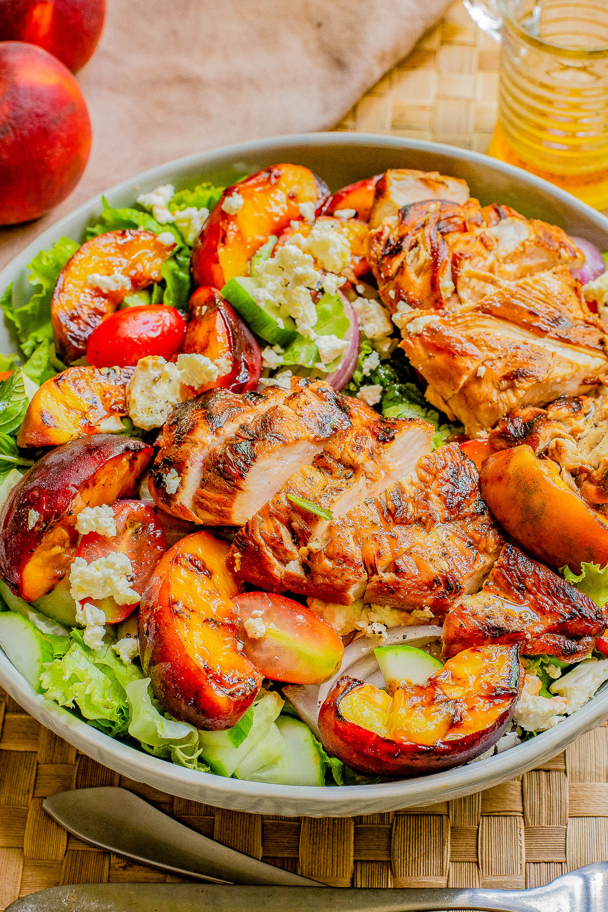 Grilled Peach and Chicken Salad with Lemon Vinaigrette — 🍑🥗🍋 Fresh peaches are grilled quickly on both sides before being tossed with juicy grilled chicken, crisp lettuce, salty feta, fresh mint, tomatoes, and more! Grilling peaches caramelizes them and infuses the salad with so much FLAVOR! Take advantage of seasonal summer produce while it lasts by making this EASY and crave-worthy salad! 
