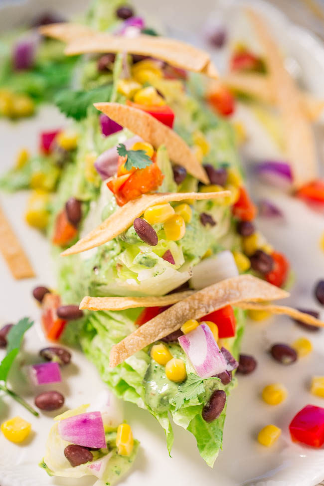 Mexican Wedge Salad with Creamy Avocado-Cilantro Dressing - A Mexican twist on the classic wedge salad with black beans, peppers, corn, crunchy tortilla strips, and more!! Easy, healthy, and the dressing is so flavorful!!