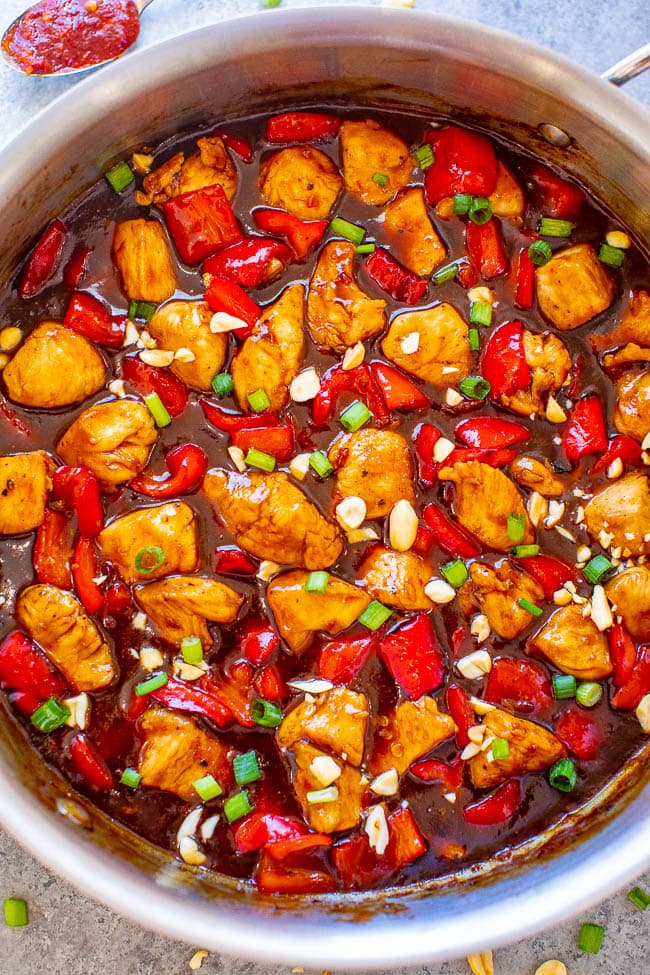 overhead view of kung pao chicken in a metal skillet 