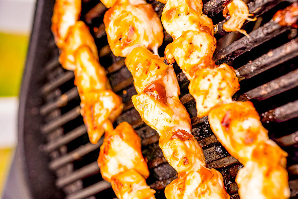 Marinated shrimp grilling on a barbecue.