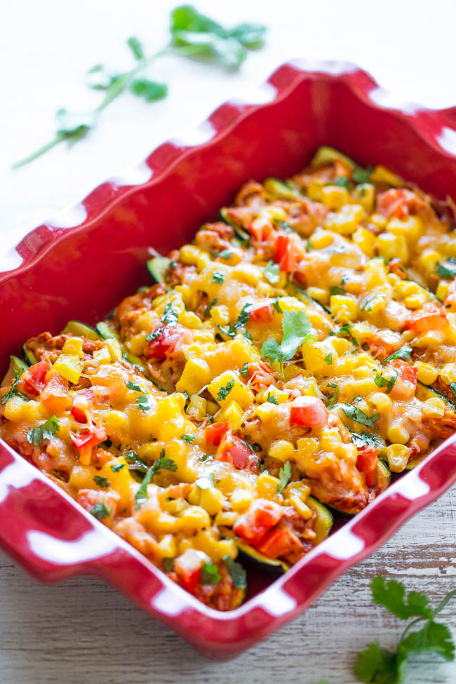 overhead view of stuffed zucchini boats in a red baking dish