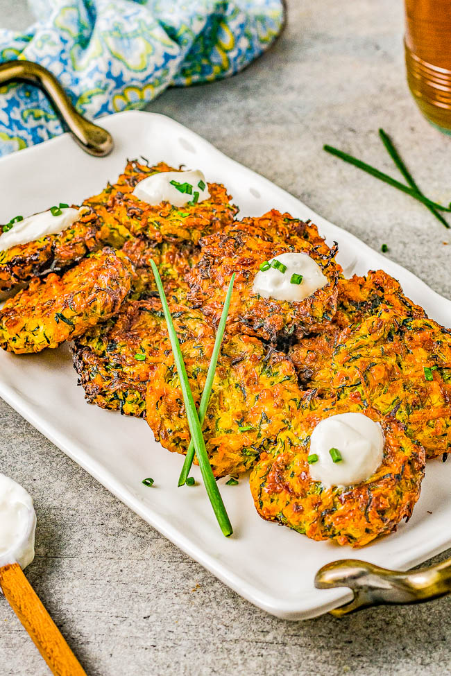 Air Fryer Zucchini Fritters - Lightly crisped on the outside, tender on the inside, and makes use of summer's most abundant vegetable! And air frying the zucchini fritters keeps them healthier than actual frying without sacrificing taste or texture! Perfect as an appetizer, side dish, or healthy main course. Oven baking instructions also provided.