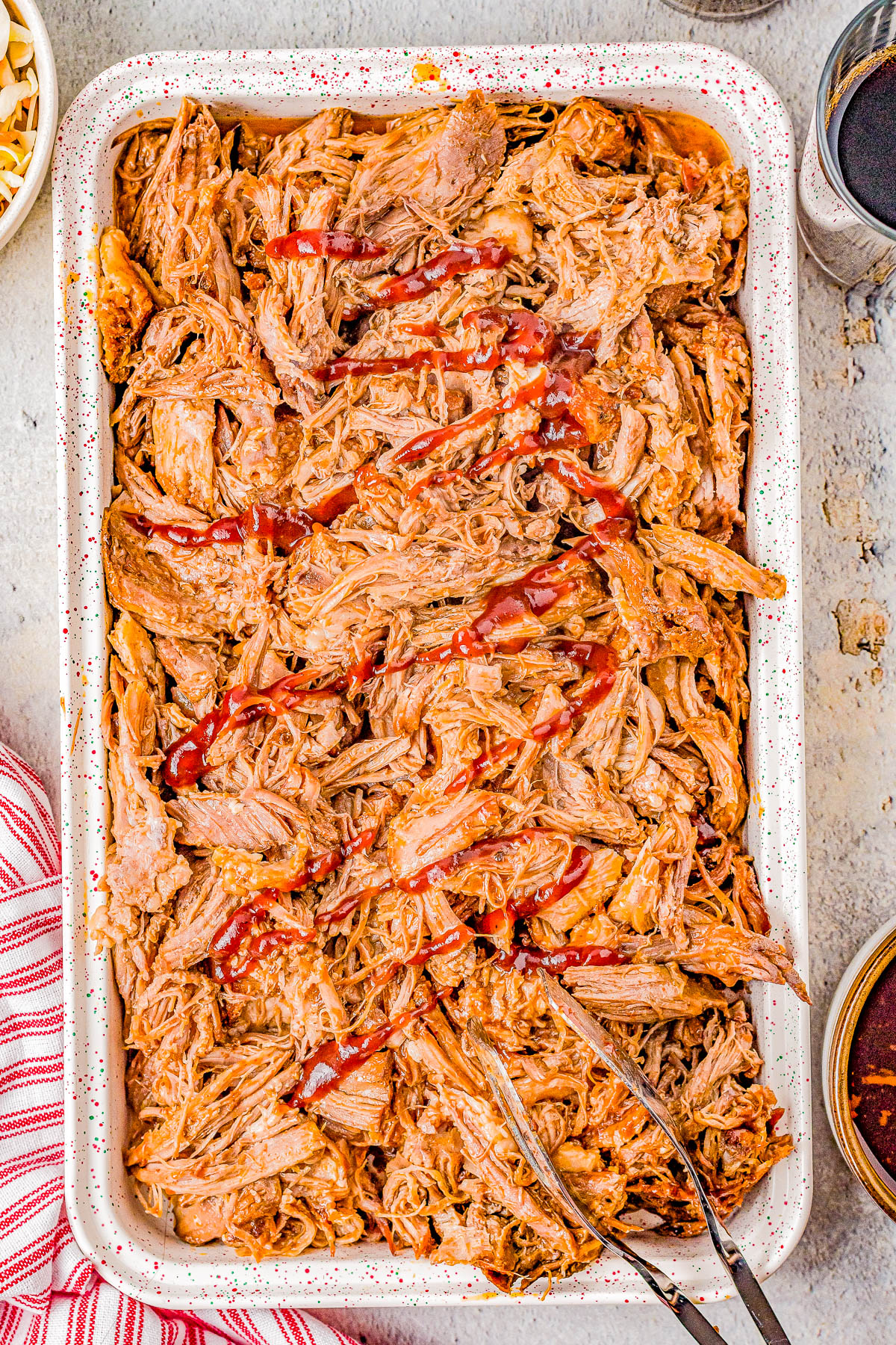 Slow Cooker Cherry Cola Pulled Pork - Super juicy, smoky, tangy-and-sweet pulled pork that is just bursting with flavor and moisture thanks to Cherry Coke and barbecue sauce! The EASIEST recipe because your Crock-Pot does all the work! Perfect for Memorial Day, Father's Day, barbecues, potlucks, game day events, and more.