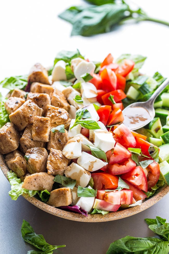 caprese salad with lettuce in a wooden bowl