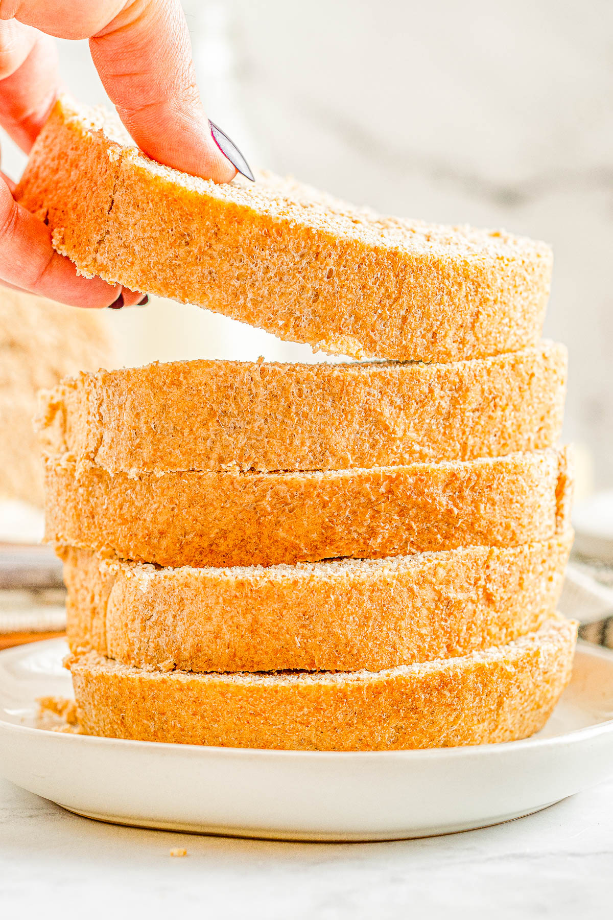 Honey Whole Wheat Bread - An EASY and foolproof homemade bread recipe for honey sweetened whole wheat bread! It's soft, thick, and scrumptious! Serve it plain, toast it, make sandwiches with it, or serve it with honey butter which is my favorite! Even if you're never made bread before, my recipe is straightforward and do-able.