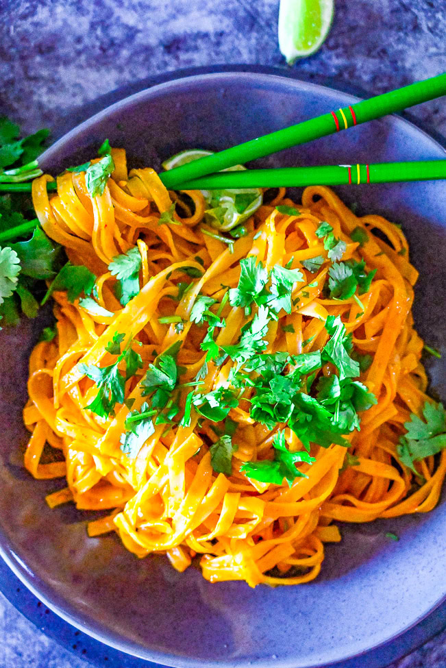 overhead view of Asian pork noodles in a skillet 