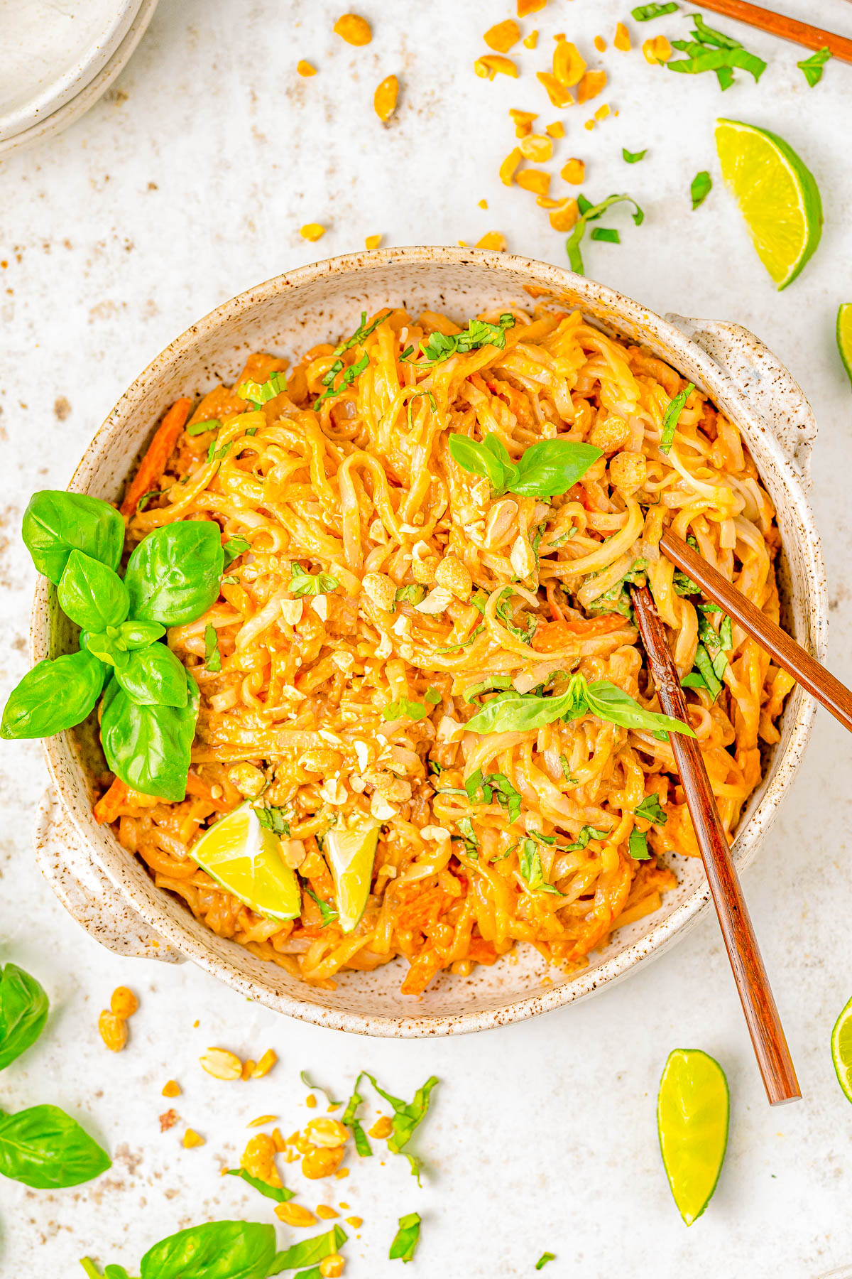 15-Minute Spicy Peanut Noodles - Drenched in spicy peanut sauce, this EASY recipe for peanut noodles is faster than calling for takeout! Homemade peanut sauce is amped up with sesame oil, ginger, soy, sriracha, and tossed with rice noodles for a great quick and easy lunch or busy weeknight dinner. Vegetarian and gluten-free comfort food that'll keep you satisfied for hours! Adding your favorite protein is always welcome.