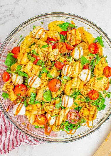 Tortellini Caprese Pasta Salad - 🥗🍅🌿🧀 All the flavors of traditional caprese salad including tomatoes, mozzarella, and basil, but with cheese tortellini to add a comfort food factor that everyone ADORES! Tossed in a light balsamic vinaigrette which adds loads of flavor without being heavy. So EASY, ready in 20 minutes, perfect for summer days, a quick work lunch, or as a family favorite dinner side dish!