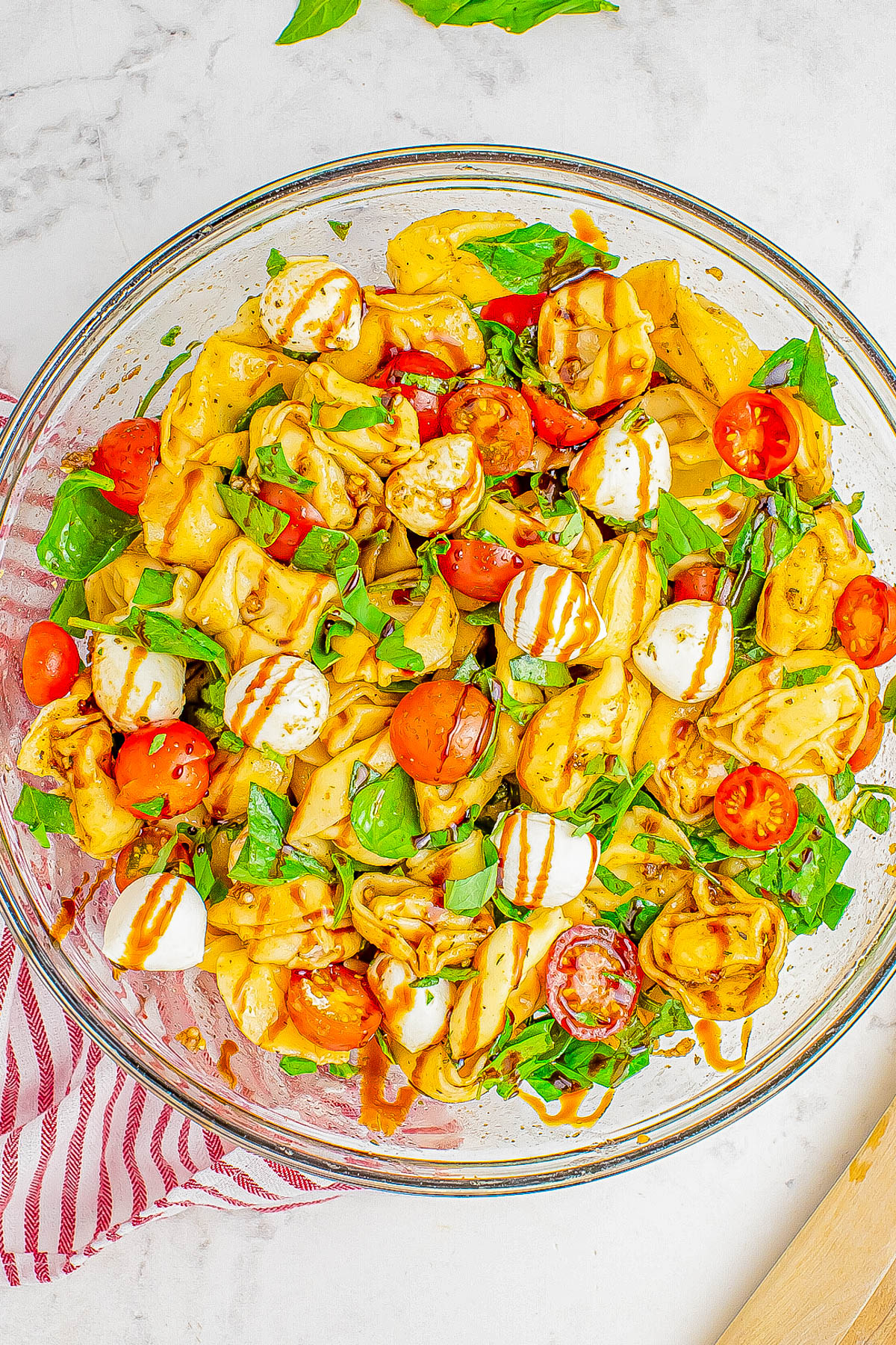 Tortellini Caprese Pasta Salad - 🥗🍅🌿🧀 All the flavors of traditional caprese salad including tomatoes, mozzarella, and basil, but with cheese tortellini to add a comfort food factor that everyone ADORES! Tossed in a light balsamic vinaigrette which adds loads of flavor without being heavy. So EASY, ready in 20 minutes, perfect for summer days, a quick work lunch, or as a family favorite dinner side dish!