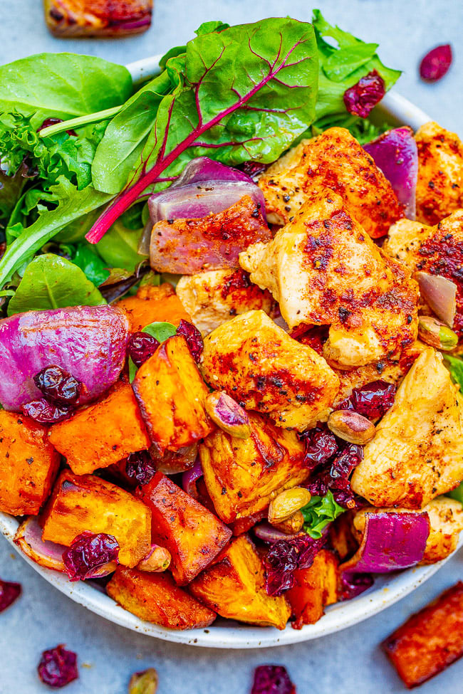 Roasted Chicken and Sweet Potato Salad — Fall-inspired ingredients including tender sweet potatoes, juicy chicken, red onions, cranberries, and pumpkin seeds topped with a honey apple cider vinaigrette!!  A HEARTY and COMFORTING salad that makes a big batch perfect for planned leftovers!!