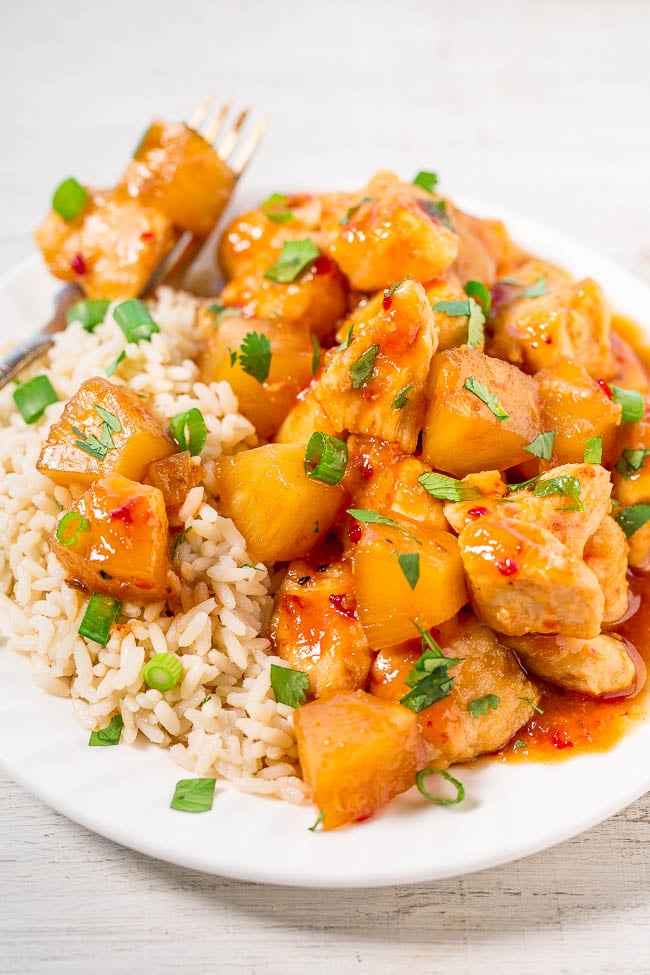 Slow Cooker Hawaiian Chicken with Pineapple atop bed of white rice on plate with fork